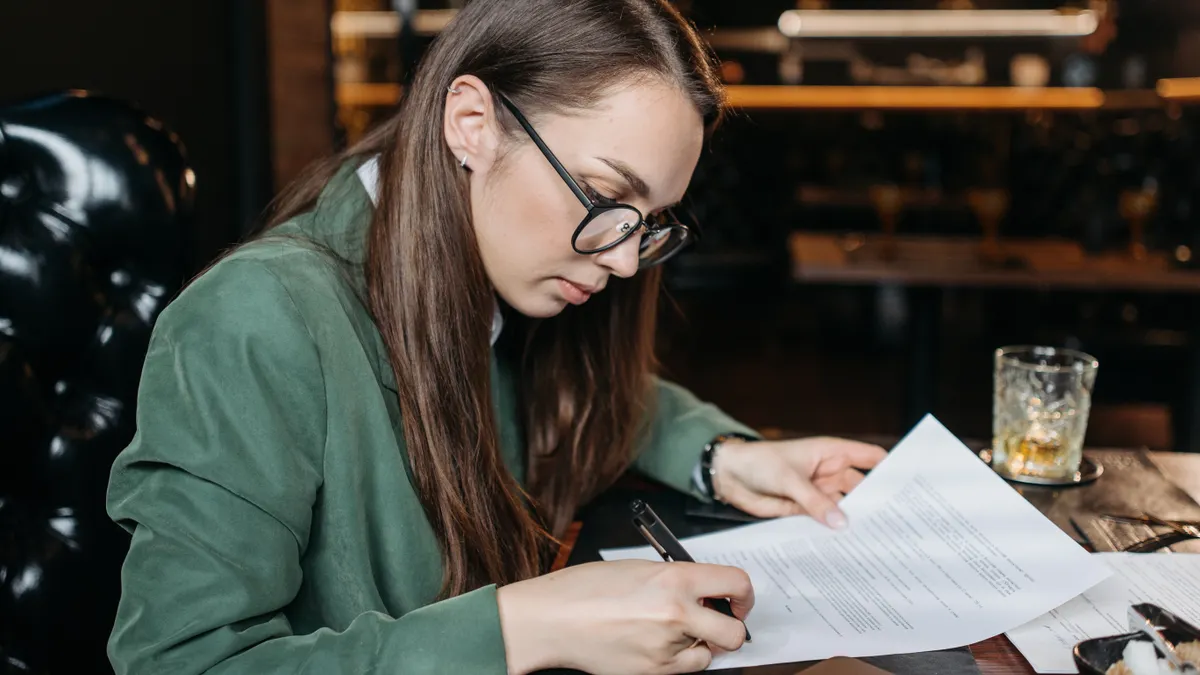 Best SaaS Tools for Document Signing — A Woman Signing a Document