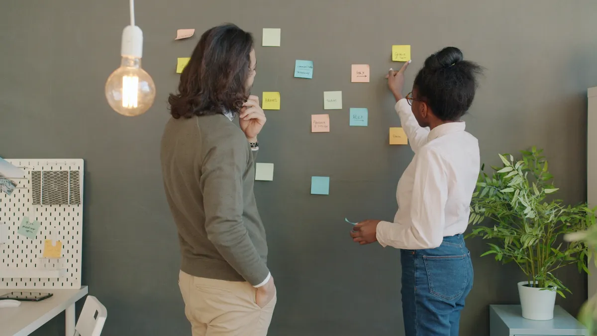 team placing sticky notes on a planning wall