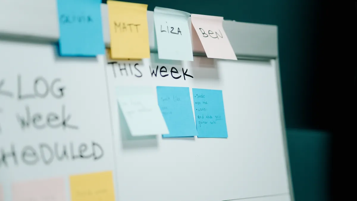 whiteboard covered with sticky notes for planning