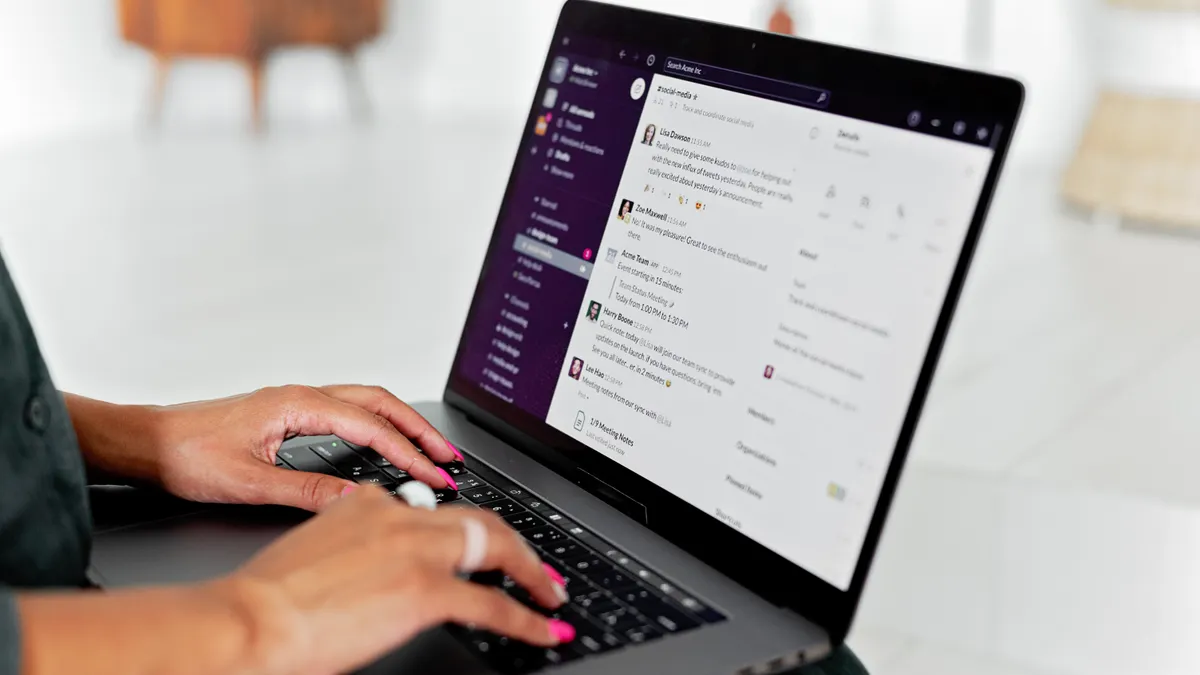 Best SaaS tools for startups: tools for the first 10 hires Person typing in a team chat app on a laptop