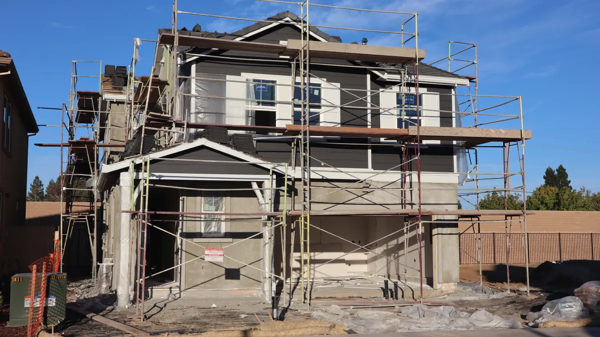 SaaS Comparison Framework: How to Compare Two Tools Side by Side — Two-Story House Under Construction with Scaffolding