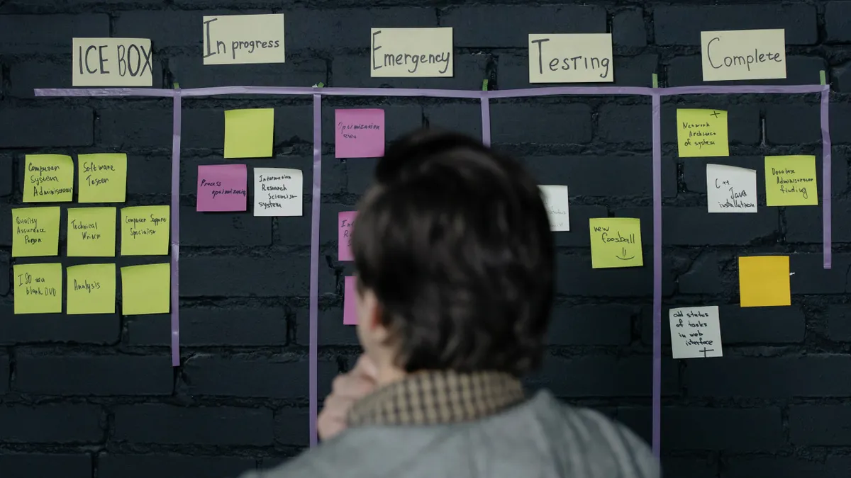 Person reviewing a kanban-style workflow board